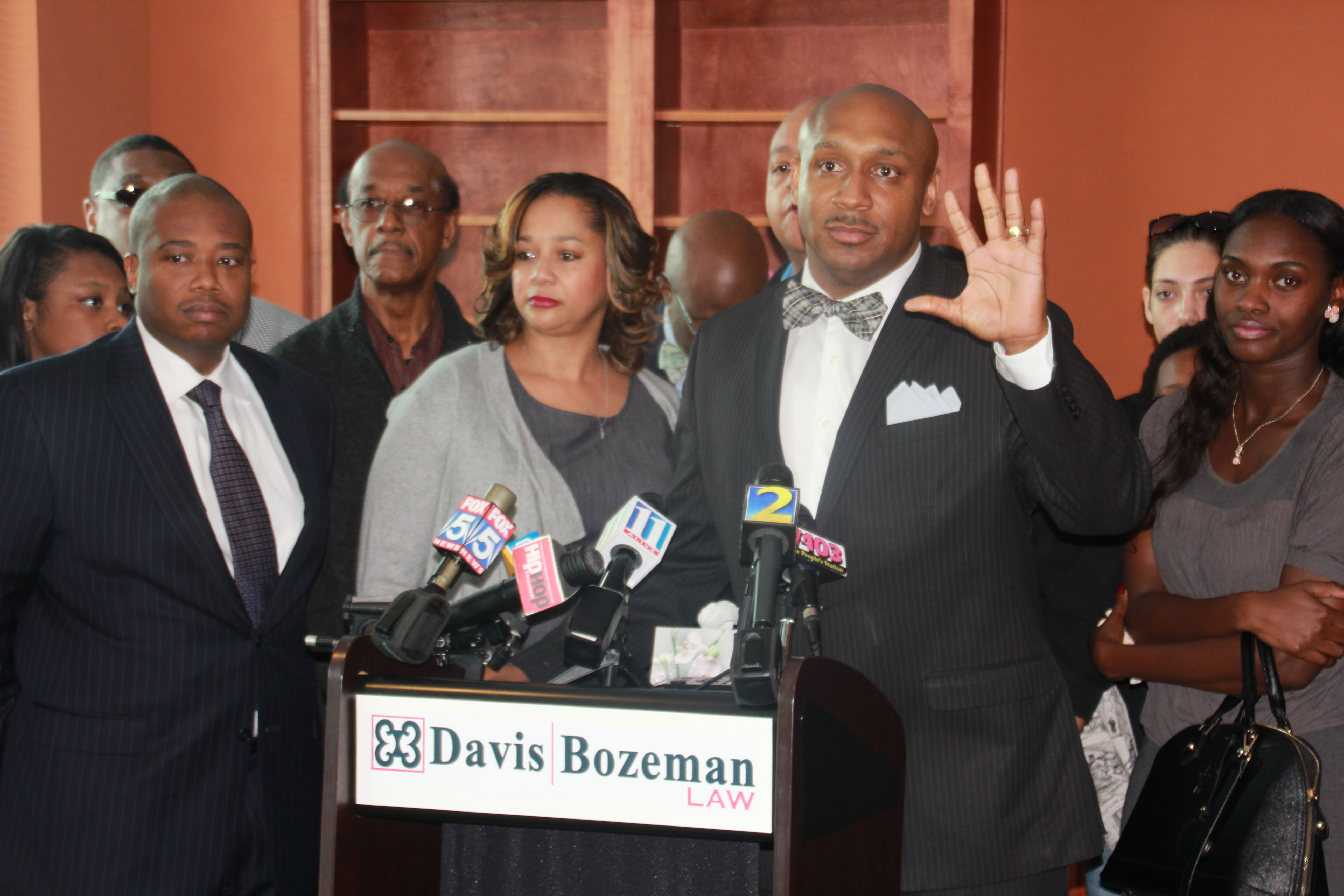The attorneys for Nicholas Thomas' family, Robert Bozeman, left, and Mawuli Davis (hand raised) question several of the facts that Smyrna police gave to the media as justification for the shooting. 
