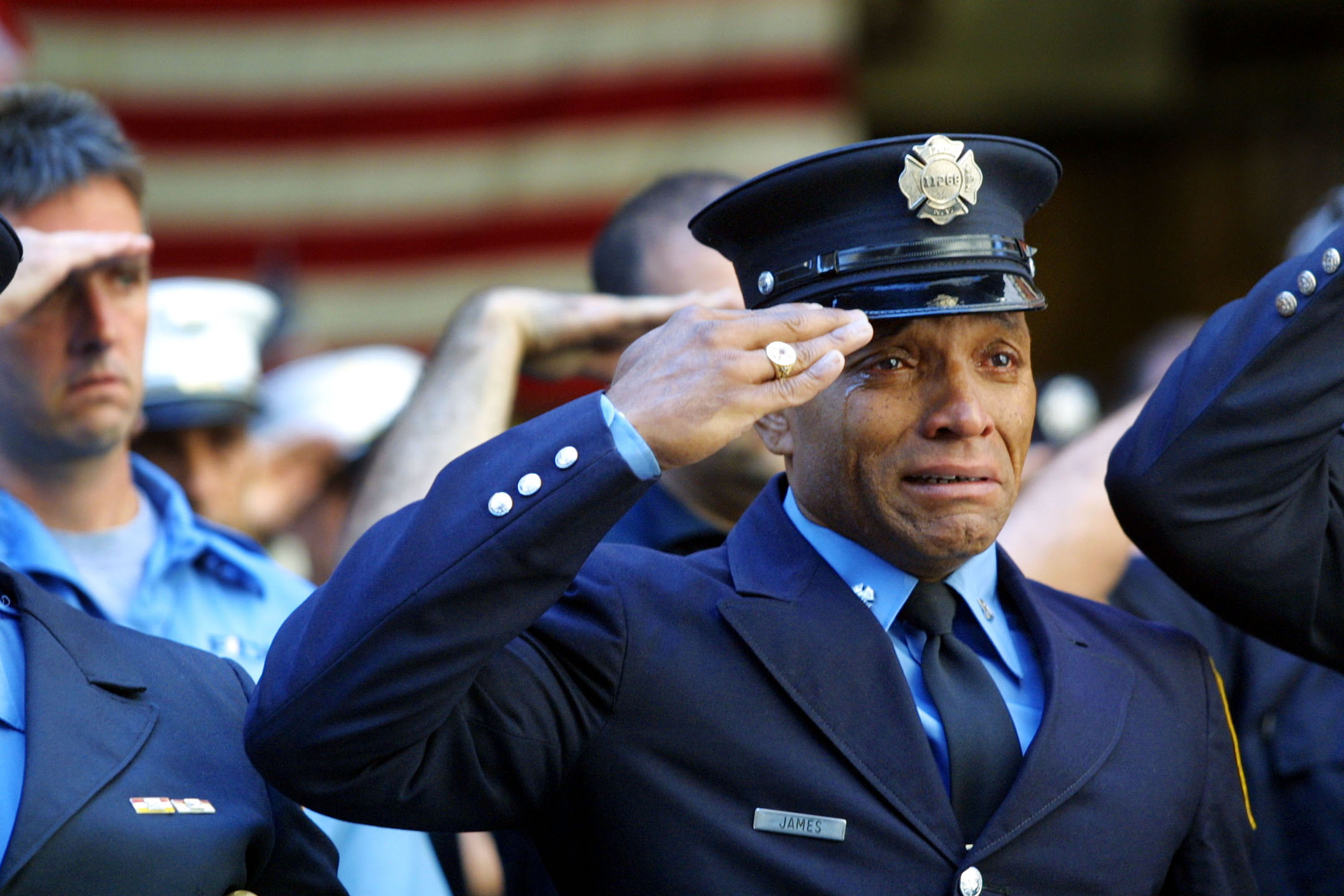 394471 13: Firefighter Tony James cries while attending the funeral service for New York Fire Department Chaplain Rev. Mychal Judge, in front of the St. Francis of Assisi Church September 15, 2001 in New York City. Judge died while giving the last rites to a fireman in the collapse of the World Trade Center. The World Trade Center was destroyed after both the landmark towers were struck by two hijacked planes in an alleged terrorist attack on September 11. (Photo by Joe Raedle/Getty Images)