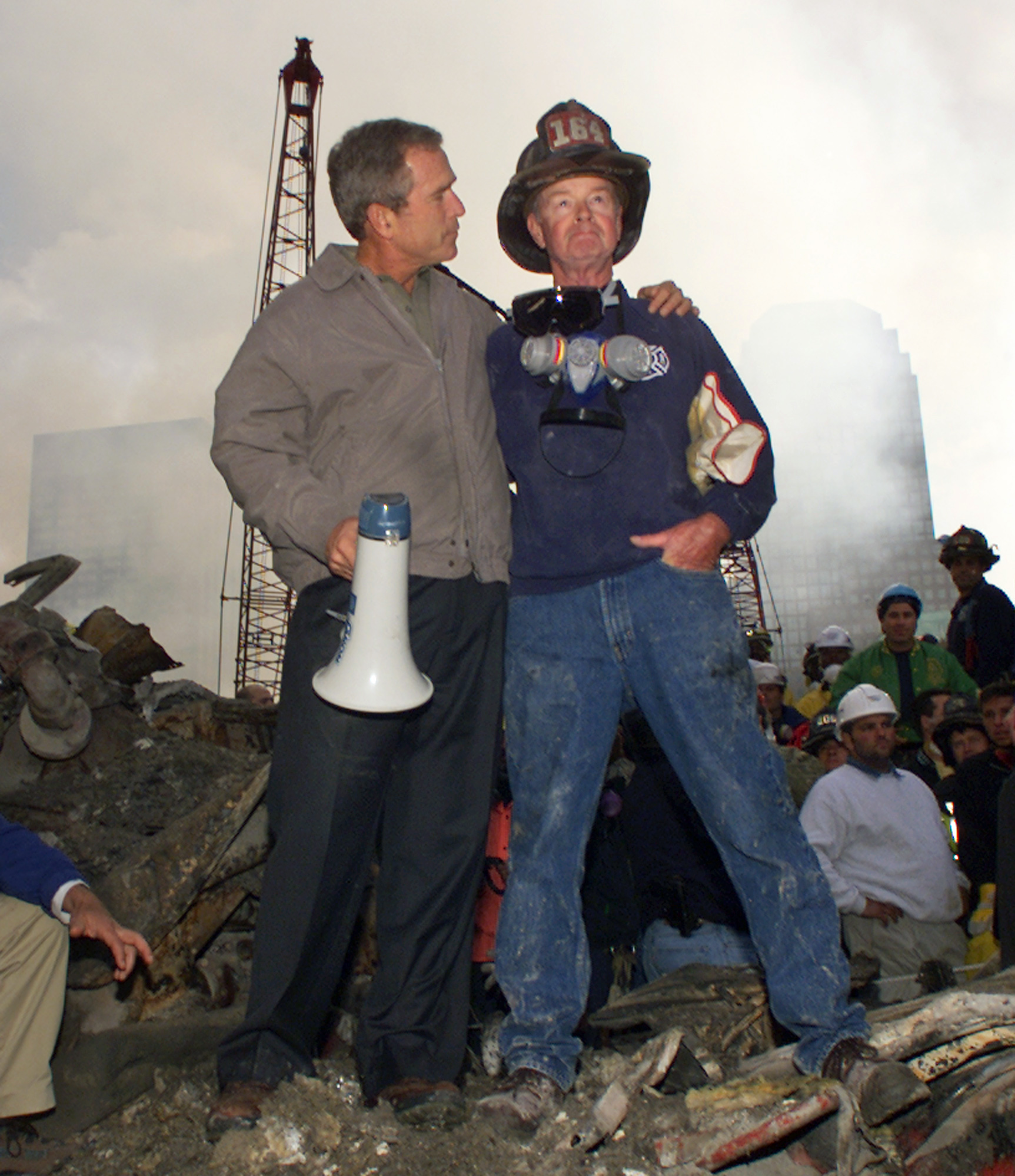 FILE - In this Sept. 14, 2001 file photo, President George W. Bush embraces firefighter Bob Beckwith while standing in front of the collapsed World Trade Center buildings in New York as rescue efforts continue. (AP Photo/Doug Mills)