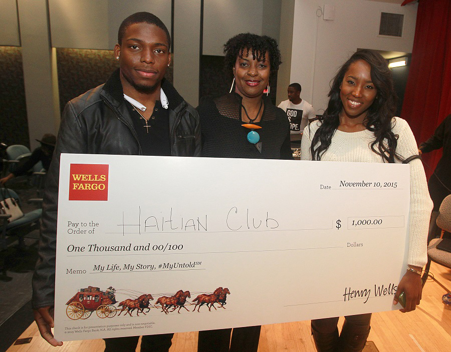 Vice President, African American segment manager for Wells Fargo, Lisa Frison center, presents the Wells Fargo award check to Spelman College Haitian Club $1,000 to fund community initiatives during the My Life, My Story, #MyUntold℠ Town Hall on November 10, 2015 at the Atlanta University Center Consortium in Atlanta, GA. (Photo by Donald Trail/Invision for Wells Fargo/AP Images)