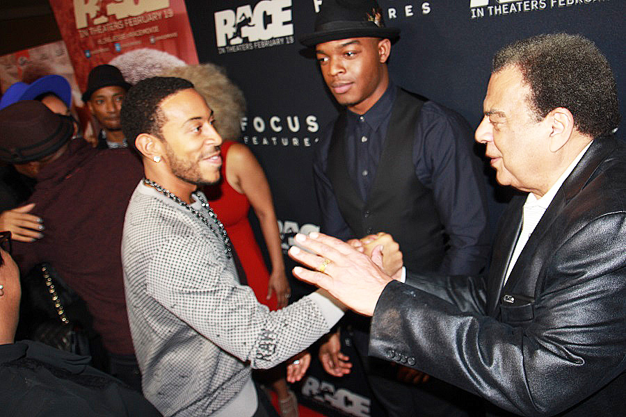 Ludacris greets Ambassador Young as "Race" star Stephan James looks on. 