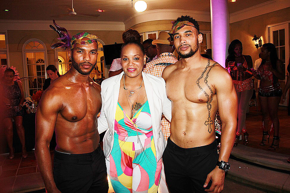 Author Joyce Reed sandwiched by sculpted masculinity at Quad Webb-Lunceford's B-Day bash. 