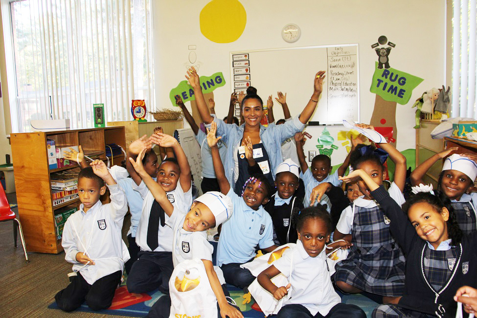 Ludacris wife, Eudoxie, surrounded by exuberant students at Carrie Steel Pitts Life Learning Center. 