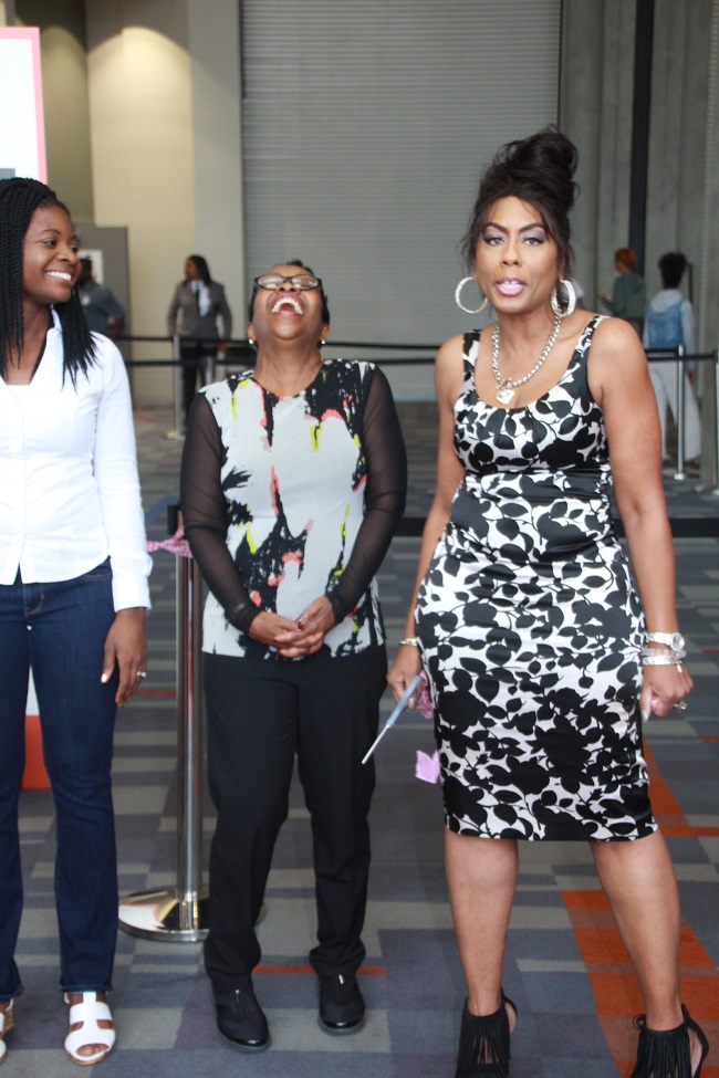 Sasha the Diva entertains the crown as Black Women's Expo founder Merry Reed (center) laughs resoundingly. 