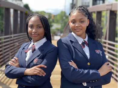 Black Girl duo smile with their arms folded after winning Harvard Debate Competition
